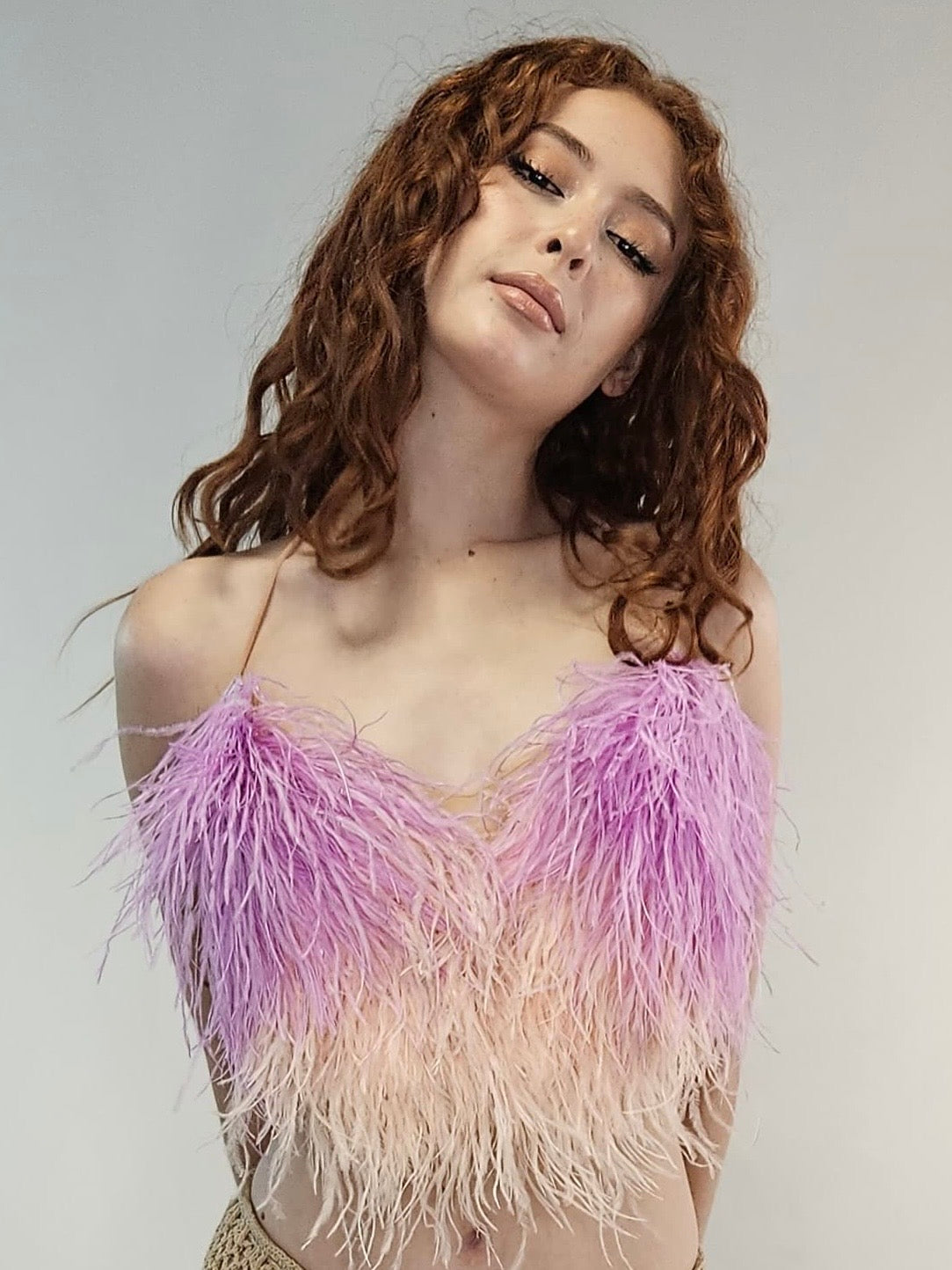 luxurious ostrich feather halter top, dyed ostrich feathers, halter neckline, adjustable ties, bare-back top, glamorous feather top, high-fashion feathered top, elegant evening wear, statement feather top, upscale event top, special occasion outfit, sleek feather design, opulent fashion top, couture feather halter